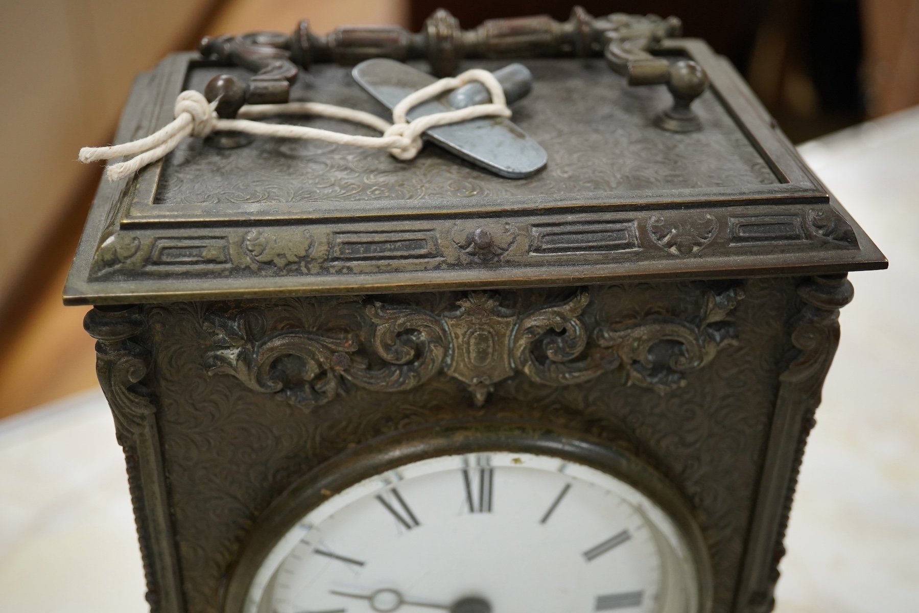 A brass overlaid mantel clock with key and pendulum, striking on a bell, 26cm high